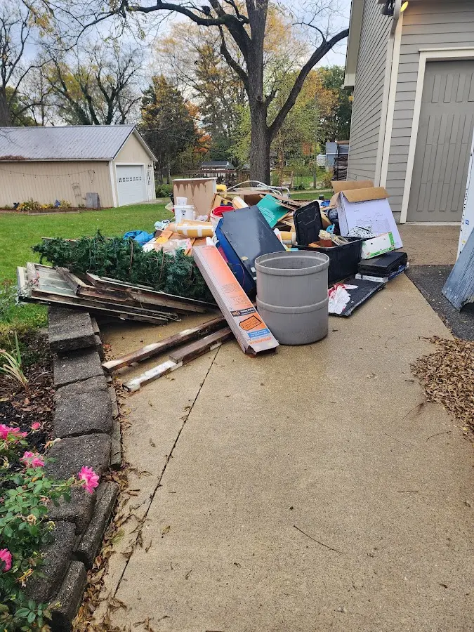 Dumpster being loaded with debris for 12 Yard Dumpster Rental in Nahant